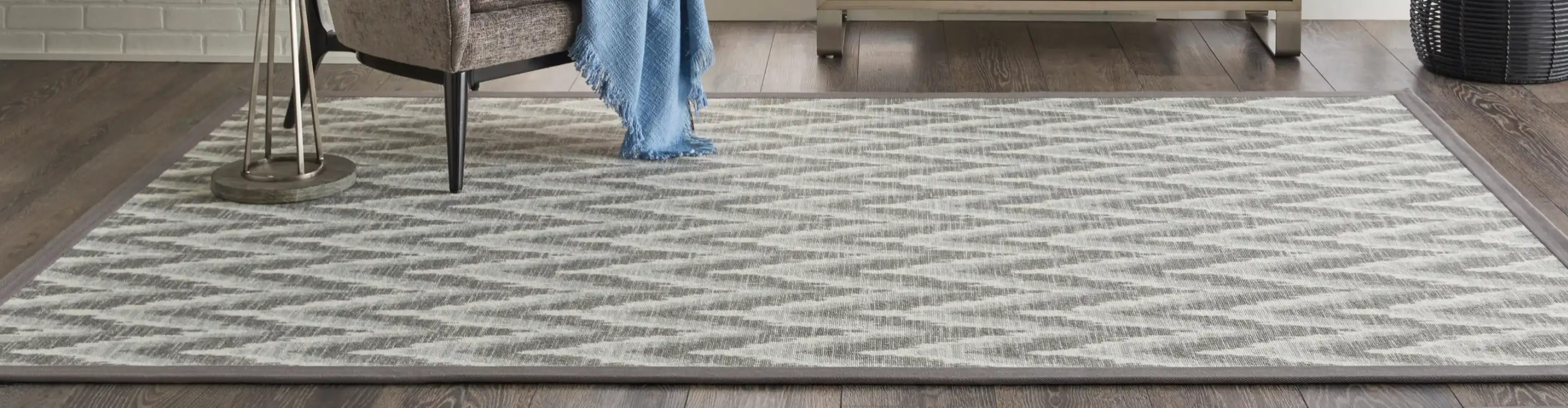 Grey patterned area rug in room